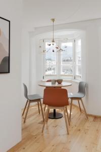 a dining room with a table and chairs at Das Grüne Haus - Boutique Apartments ecofriendly in Innsbruck