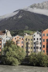 een groep gebouwen naast een waterlichaam bij Das Grüne Haus - Boutique Apartments ecofriendly in Innsbruck