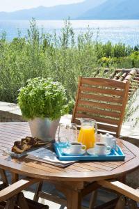 a wooden table with a tray of food and orange juice at Kotronas Bay Bungalows in Kotronas