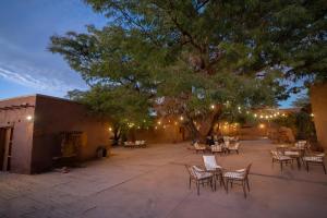 a patio with tables and chairs at night at Hotel Don Raul in San Pedro de Atacama
