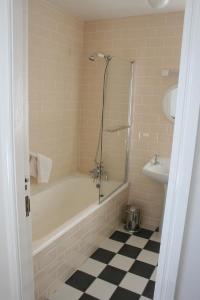 a bathroom with a shower and a tub and a sink at Roundstone House Hotel in Roundstone