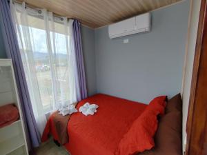 ein Schlafzimmer mit einem roten Bett und einem Fenster in der Unterkunft Apartamento de una habitación in San Isidro