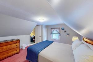 a bedroom with a white bed and a window at Harbor Haven in Bass Harbor