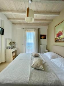 A bed or beds in a room at Koumaros Villas