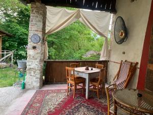 a table and chairs on a patio with a window at Relais Borgo Poggetello in Tagliacozzo