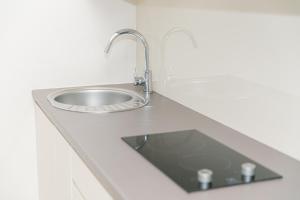 a sink in a white counter with a faucet at VacationClub – Tignes Apartament 2 in Sienna