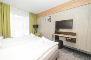 TV a/nebo společenská místnost v ubytování VacationClub - Czarna Perła Apartament 303