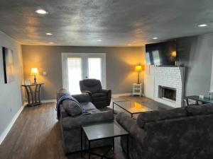 a living room with two couches and a fireplace at Gilcrease Hillside in Tulsa