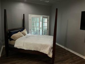 a bedroom with a large bed with white sheets at Gilcrease Hillside in Tulsa