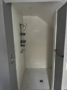 a shower stall in a bathroom with a staircase at Gilcrease Hillside in Tulsa