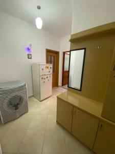 a kitchen with a refrigerator and a counter with a mirror at Dhimitrulla Guest-House in Përmet