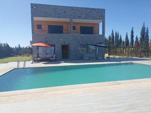 a house with a swimming pool in front of a building at Villa Nour in El Jadida