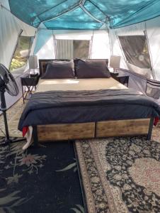 a bedroom with a bed in a tent at Glamping on the Green River in Washago