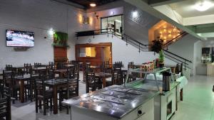 a restaurant with a bar and tables and chairs at Hotel e Restaurante do Baixinho in Planalto