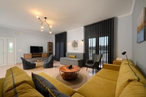 a living room with a couch and a table at Villa Alina in Lefkimmi