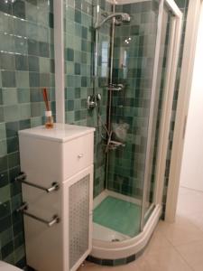 a bathroom with a shower with a glass door at VELA BLU in Ceriale