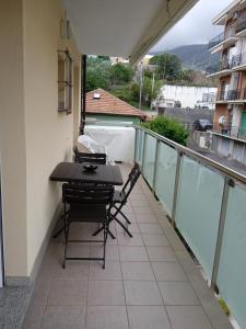 a balcony with a table and chairs on it at VELA BLU in Ceriale