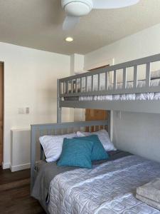 a bedroom with a bunk bed with a blue pillow at Paradise resort living Mandalay beach in Oxnard