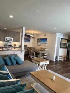 a living room and kitchen with a couch and a table at Paradise resort living Mandalay beach in Oxnard