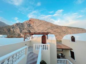 a view from the balcony of a house with a mountain at Villa Dima in Perissa