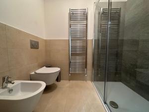 a bathroom with a toilet and a sink and a shower at Alpine Escape in Bormio +1 photo