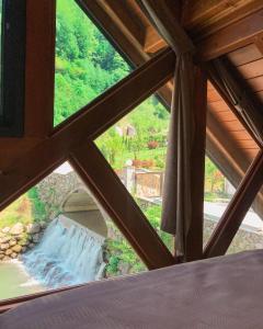 a view of a waterfall from a window at timya sapanca in Sapanca