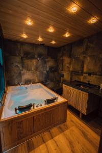 a large bath tub in a room with a sink at timya sapanca in Sapanca