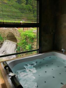 a bath tub in a room with a window at timya sapanca in Sapanca