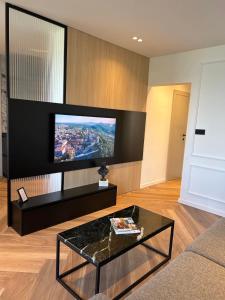 a living room with a tv and a coffee table at Canova Apartment in Labin