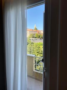 a window with a view of a city at Canova Apartment in Labin