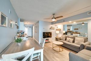 a living room with a couch and a table at Cozy Coastal Condo with Airy Oceanfront Balcony in Myrtle Beach