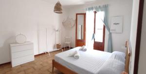 a bedroom with a white bed with towels on it at Case Vacanze Tropea La Pinnata in Tropea