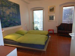 a bedroom with a bed and a couch in a room at Ferienwohnung Roeder Mühle in Peterfecking