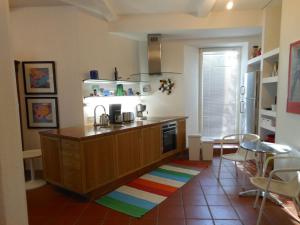 a kitchen with a sink and a counter top at Ferienwohnung Roeder Mühle in Peterfecking