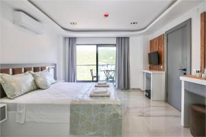 a bedroom with a large bed and a balcony at Stonehillkaş in Kas