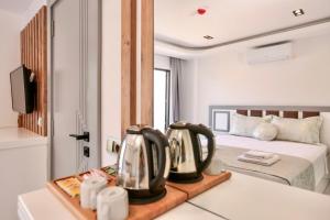 a bedroom with a bed and a table with two pans at Stonehillkaş in Kas
