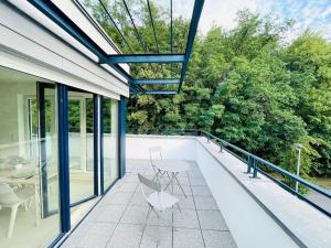 a patio with a table and chairs on a balcony at Luxury Green Penthouse Terrace&Parking - 117 in Luxembourg