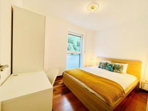 a small bedroom with a bed and a window at Luxury Green Penthouse Terrace&Parking - 117 in Luxembourg