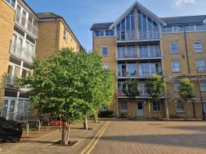 an apartment building with a tree in front of it at Newly Renovated Flat with Parking space in Canterbury