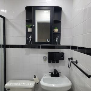 a white bathroom with a sink and a mirror at Cozy & Relax LLC Airb&b in Brooklyn