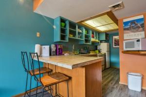 a kitchen with blue walls and a counter top at Cozy Adventure Pad Near Downtown - Rose Tree 2 in Moab