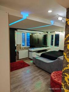 a bedroom with a bed and a room with blue lights at Apartamento Penthouse con Jacuzzi y Chimenea in Bogotá