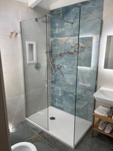 a shower with a glass door in a bathroom at San Pietro Home in San Pietro in Bevagna