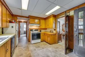 a kitchen with wooden cabinets and white appliances at 8 Mi to Elk Mountain Ski Resort Clifford Home! in Clifford