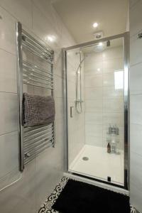 a bathroom with a shower with a glass door at Meadow Bank, fabulous apartment in Baddiley