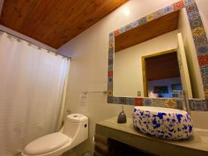 a bathroom with a sink and a mirror at Cabañas La Luz in Olmué