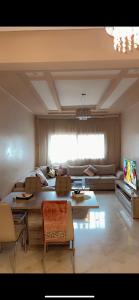 a living room with a couch and a table at Lux furnished flat Enjoy ur stay in Nouaceur