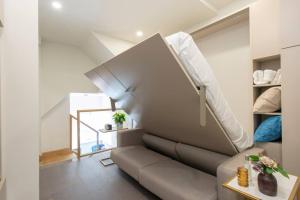 a living room with a couch and a staircase at City Life Bliss Central Studio in Reading CHRL F3 in Reading