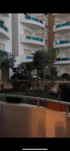 a view of a building with trees in front of it at Lux furnished flat Enjoy ur stay in Nouaceur