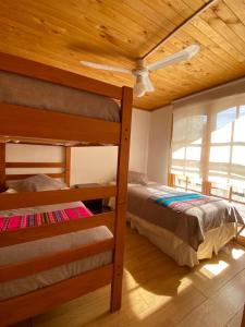 a bedroom with two bunk beds and a ceiling fan at Cabañas Doña Juanita in San Pedro de Atacama